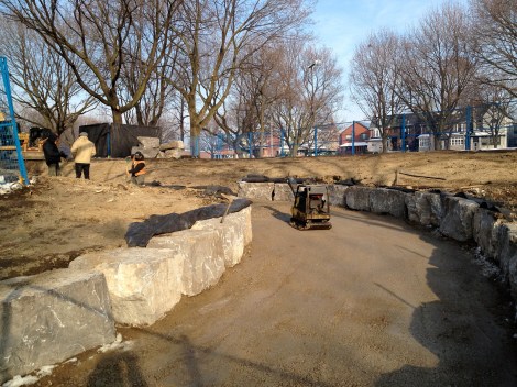 Limestone boulders continue to be placed along sides of ramp